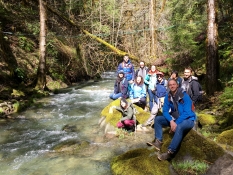 Students studying a river from a bridge